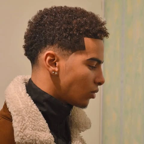 Men's Summer Hairstyles That Beat the Heat in Style 8 The Curly Top with Low Fade